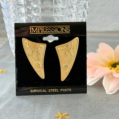 Vintage JJ Jonette 1986 gold‑tone sun and star geometric earrings on original card, textured metal, NOS condition.