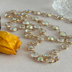 Vintage Swarovski long necklace with bezel‑set AB clear crystal coin stones in gold‑tone metal, signed with Swarovski swan hang tag.