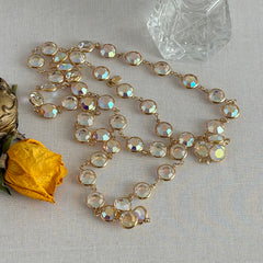 Vintage Swarovski long necklace with bezel‑set AB clear crystal coin stones in gold‑tone metal, signed with Swarovski swan hang tag.