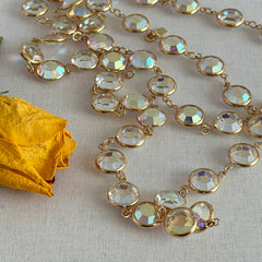 Vintage Swarovski long necklace with bezel‑set AB clear crystal coin stones in gold‑tone metal, signed with Swarovski swan hang tag.