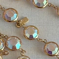 Vintage Swarovski long necklace with bezel‑set AB clear crystal coin stones in gold‑tone metal, signed with Swarovski swan hang tag.