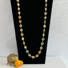 Vintage Swarovski long necklace with bezel‑set AB clear crystal coin stones in gold‑tone metal, signed with Swarovski swan hang tag.
