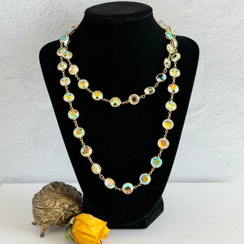 Vintage Swarovski long necklace with bezel‑set AB clear crystal coin stones in gold‑tone metal, signed with Swarovski swan hang tag.