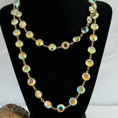 Vintage Swarovski long necklace with bezel‑set AB clear crystal coin stones in gold‑tone metal, signed with Swarovski swan hang tag.