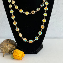 Vintage Swarovski long necklace with bezel‑set AB clear crystal coin stones in gold‑tone metal, signed with Swarovski swan hang tag.