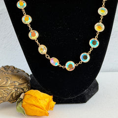 Vintage Swarovski long necklace with bezel‑set AB clear crystal coin stones in gold‑tone metal, signed with Swarovski swan hang tag.