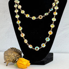 Vintage Swarovski long necklace with bezel‑set AB clear crystal coin stones in gold‑tone metal, signed with Swarovski swan hang tag.