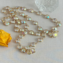 Vintage Swarovski long necklace with bezel‑set AB clear crystal coin stones in gold‑tone metal, signed with Swarovski swan hang tag.
