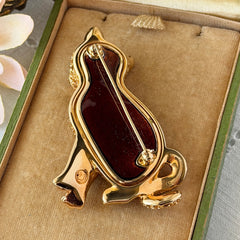 Vintage Swarovski cat brooch from the 1996 Precious Pets collection with hand‑polished gold‑plated setting, topaz and smoked topaz pavé crystals, green cabochon eyes, and honey‑brown enamel back, shown in various angles and lighting.