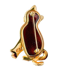Vintage Swarovski cat brooch from the 1996 Precious Pets collection with hand‑polished gold‑plated setting, topaz and smoked topaz pavé crystals, green cabochon eyes, and honey‑brown enamel back, shown in various angles and lighting.