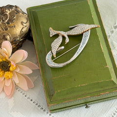 Vintage Swarovski 1999 Freedom Bird brooch with mixed gold‑ and silver‑tone metal and clear pavé crystals, shown from various angles to highlight its sculptural shape and condition.