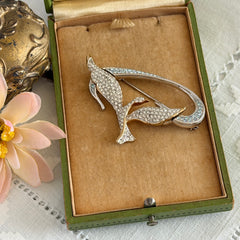 Vintage Swarovski 1999 Freedom Bird brooch with mixed gold‑ and silver‑tone metal and clear pavé crystals, shown from various angles to highlight its sculptural shape and condition.