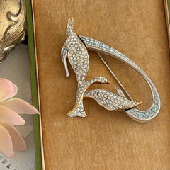 Vintage Swarovski 1999 Freedom Bird brooch with mixed gold‑ and silver‑tone metal and clear pavé crystals, shown from various angles to highlight its sculptural shape and condition.