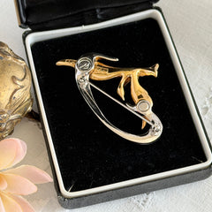 Vintage Swarovski 1999 Freedom Bird brooch with mixed gold‑ and silver‑tone metal and clear pavé crystals, shown from various angles to highlight its sculptural shape and condition.