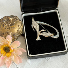 Vintage Swarovski 1999 Freedom Bird brooch with mixed gold‑ and silver‑tone metal and clear pavé crystals, shown from various angles to highlight its sculptural shape and condition.