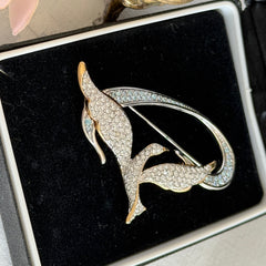 Vintage Swarovski 1999 Freedom Bird brooch with mixed gold‑ and silver‑tone metal and clear pavé crystals, shown from various angles to highlight its sculptural shape and condition.