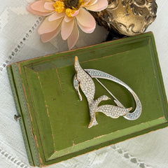 Vintage Swarovski 1999 Freedom Bird brooch with mixed gold‑ and silver‑tone metal and clear pavé crystals, shown from various angles to highlight its sculptural shape and condition.