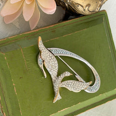 Vintage Swarovski 1999 Freedom Bird brooch with mixed gold‑ and silver‑tone metal and clear pavé crystals, shown from various angles to highlight its sculptural shape and condition.