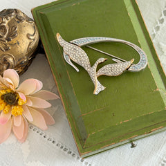 Vintage Swarovski 1999 Freedom Bird brooch with mixed gold‑ and silver‑tone metal and clear pavé crystals, shown from various angles to highlight its sculptural shape and condition.