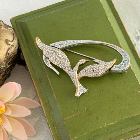 Vintage Swarovski 1999 Freedom Bird brooch with mixed gold‑ and silver‑tone metal and clear pavé crystals, shown from various angles to highlight its sculptural shape and condition.