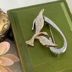 Vintage Swarovski 1999 Freedom Bird brooch with mixed gold‑ and silver‑tone metal and clear pavé crystals, shown from various angles to highlight its sculptural shape and condition.