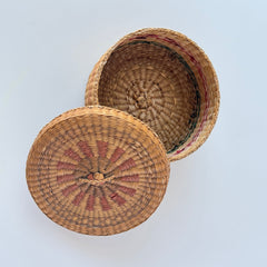 Vintage round sweetgrass basket with lid featuring a red and black woven pattern, shown from multiple angles to highlight its craftsmanship and natural texture.