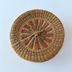 Vintage round sweetgrass basket with lid featuring a red and black woven pattern, shown from multiple angles to highlight its craftsmanship and natural texture.