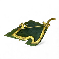 Vintage Swoboda brooch featuring a carved green jade leaf and a cluster of round carnelian berries set in gold‑tone metal, shown from multiple angles to highlight its details and signature.