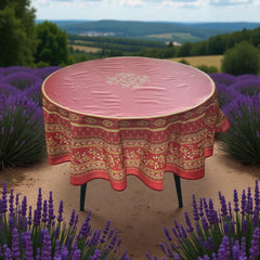 Round coated cotton tablecloth in deep red and golden yellow, featuring ornate Provençal floral and geometric patterns
