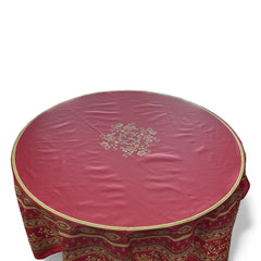 Round coated cotton tablecloth in deep red and golden yellow, featuring ornate Provençal floral and geometric patterns