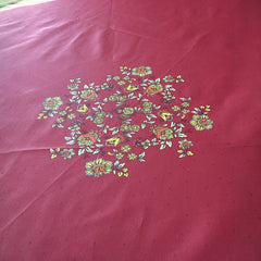 Round coated cotton tablecloth in deep red and golden yellow, featuring ornate Provençal floral and geometric patterns