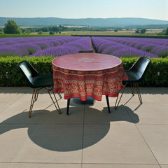 Round coated cotton tablecloth in deep red and golden yellow, featuring ornate Provençal floral and geometric patterns