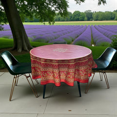 Round coated cotton tablecloth in deep red and golden yellow, featuring ornate Provençal floral and geometric patterns