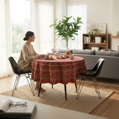 Round coated cotton tablecloth in deep red and golden yellow, featuring ornate Provençal floral and geometric patterns