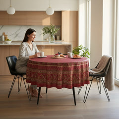 Round coated cotton tablecloth in deep red and golden yellow, featuring ornate Provençal floral and geometric patterns