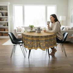 Round coated cotton tablecloth in sunny yellow and deep blue, featuring alternating Provençal floral and geometric bands