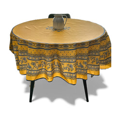 Round coated cotton tablecloth in sunny yellow and deep blue, featuring alternating Provençal floral and geometric bands