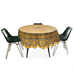 Round coated cotton tablecloth in sunny yellow and deep blue, featuring alternating Provençal floral and geometric bands