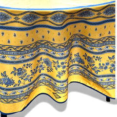 Round coated cotton tablecloth in sunny yellow and deep blue, featuring alternating Provençal floral and geometric bands