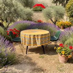 Round coated cotton tablecloth in sunny yellow and deep blue, featuring alternating Provençal floral and geometric bands