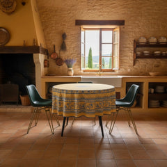 Round coated cotton tablecloth in sunny yellow and deep blue, featuring alternating Provençal floral and geometric bands