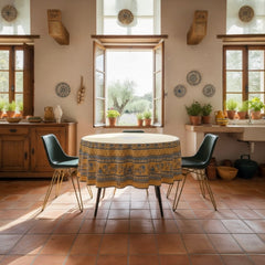 Round coated cotton tablecloth in sunny yellow and deep blue, featuring alternating Provençal floral and geometric bands