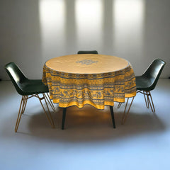 Round coated cotton tablecloth in sunny yellow and deep blue, featuring alternating Provençal floral and geometric bands