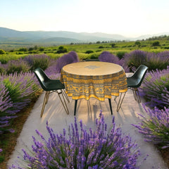 Round coated cotton tablecloth in sunny yellow and deep blue, featuring alternating Provençal floral and geometric bands