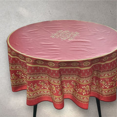 Round coated cotton tablecloth in deep red and golden yellow, featuring ornate Provençal floral and geometric patterns