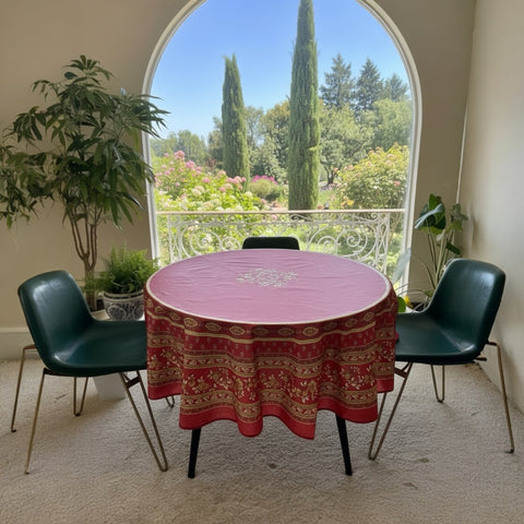 Round coated cotton tablecloth in deep red and golden yellow, featuring ornate Provençal floral and geometric patterns