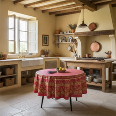 Round coated cotton tablecloth in deep red and golden yellow, featuring ornate Provençal floral and geometric patterns