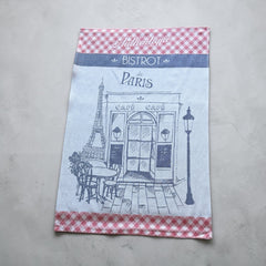 Light blue French tea towel with red gingham borders and a navy illustration of a Paris café and Eiffel Tower, by Coucke.