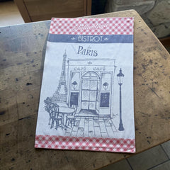 Light blue French tea towel with red gingham borders and a navy illustration of a Paris café and Eiffel Tower, by Coucke.
