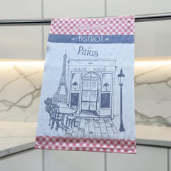 Light blue French tea towel with red gingham borders and a navy illustration of a Paris café and Eiffel Tower, by Coucke.